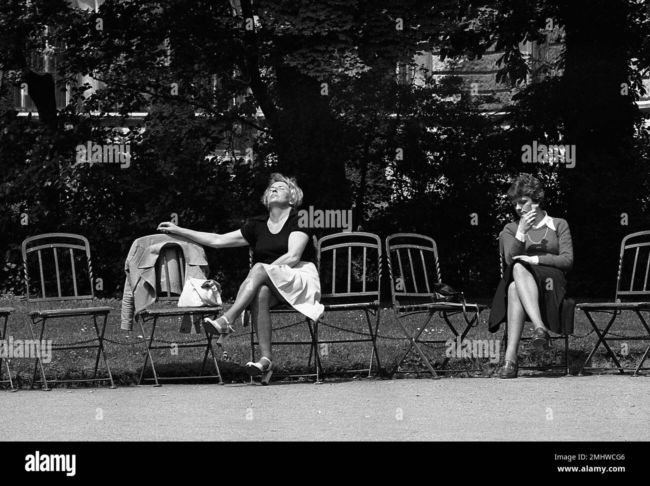 Women taking sun at a public park, Vienna, Austria, 1978 Stock Photo