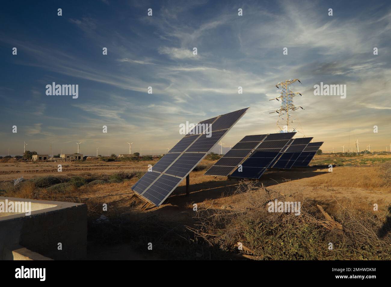 solar plates with wind turbines in the background with beautiful sunset ...