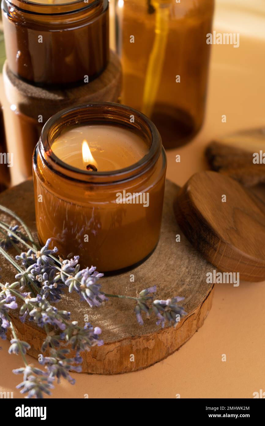 Burning candle with wooden wick on grey table Stock Photo - Alamy