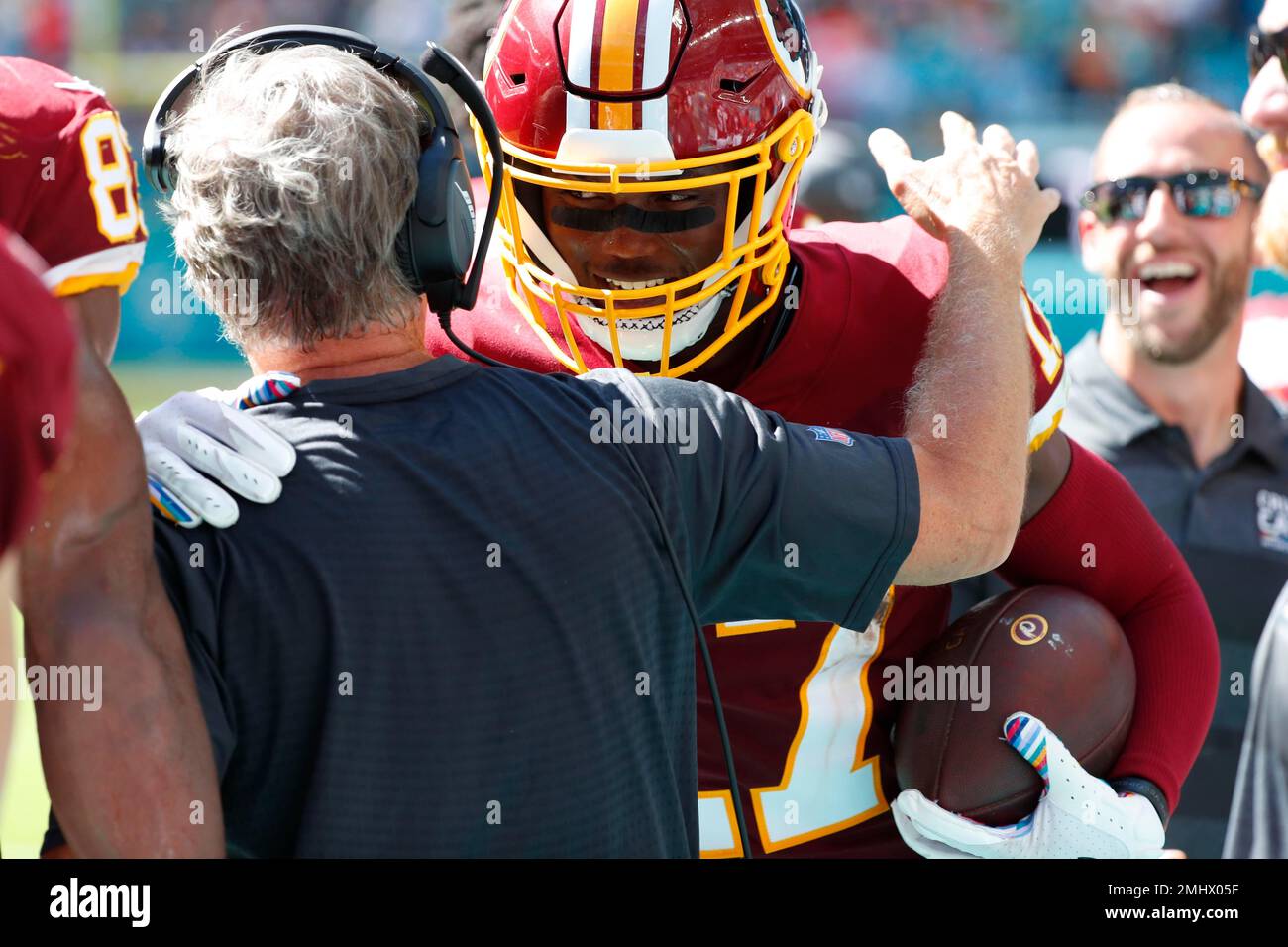 Washington Redskins interim head coach Bill Callahan congratulates wide  receiver Terry McLaurin (17) after McLaurin scored his second touchdown of  the game, during the second half at an NFL football game against