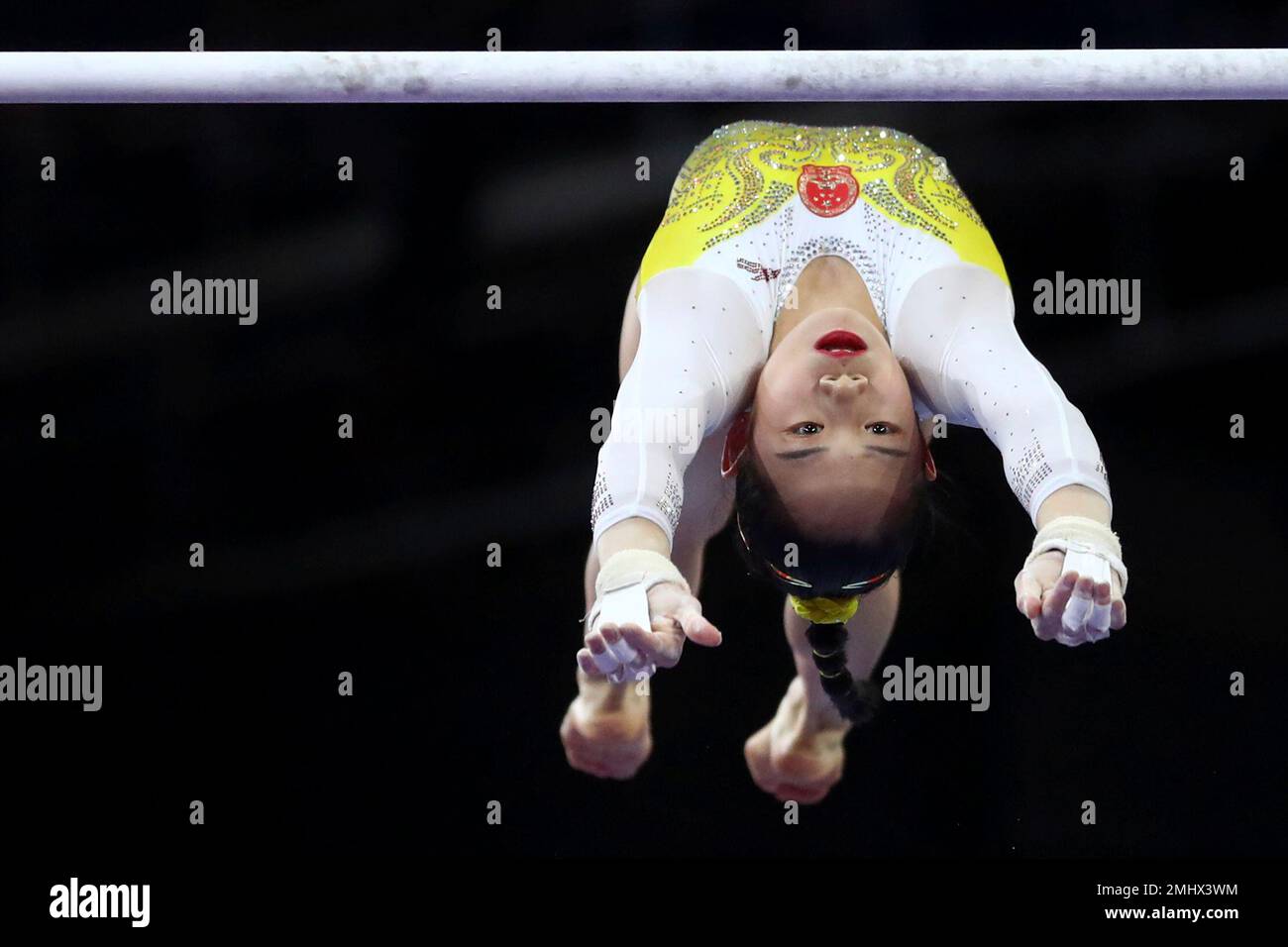 Tingting Liu of China performs on the uneven bars in the women's ...