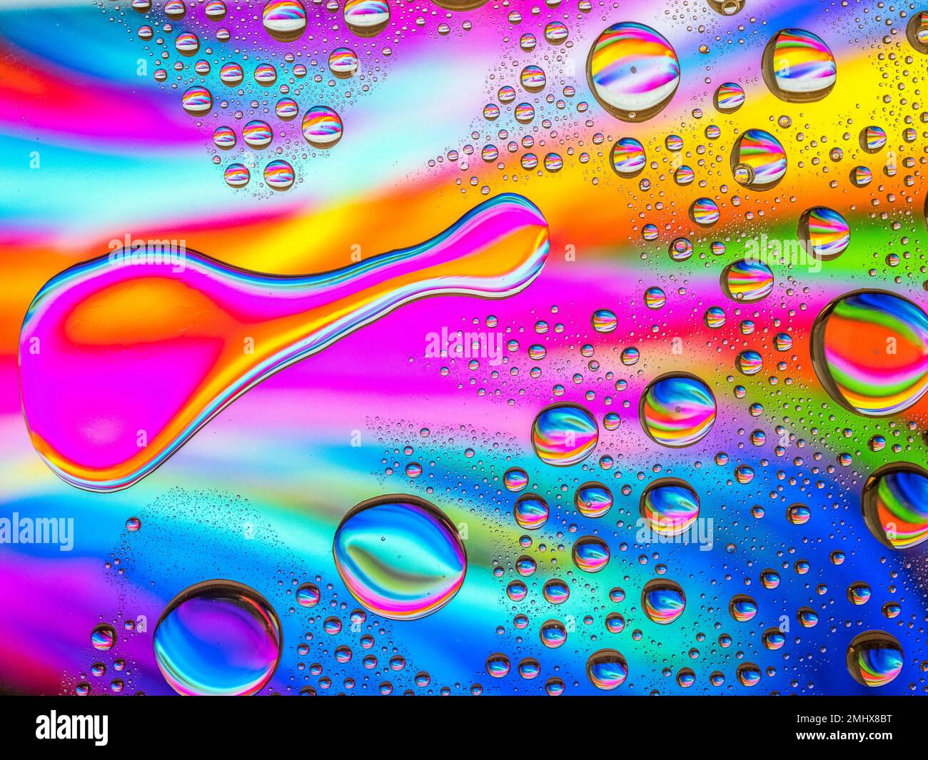 Water drops over a colorful abstract background Stock Photo - Alamy