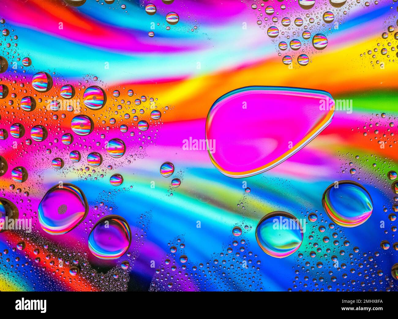 Water drops over a colorful abstract background Stock Photo - Alamy