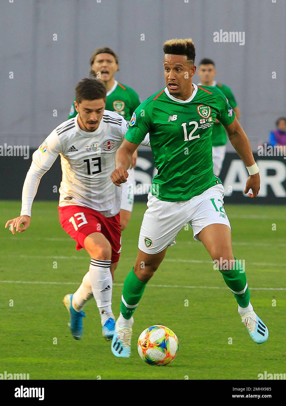 Ireland's Callum Robinson, right, fights for the ball with