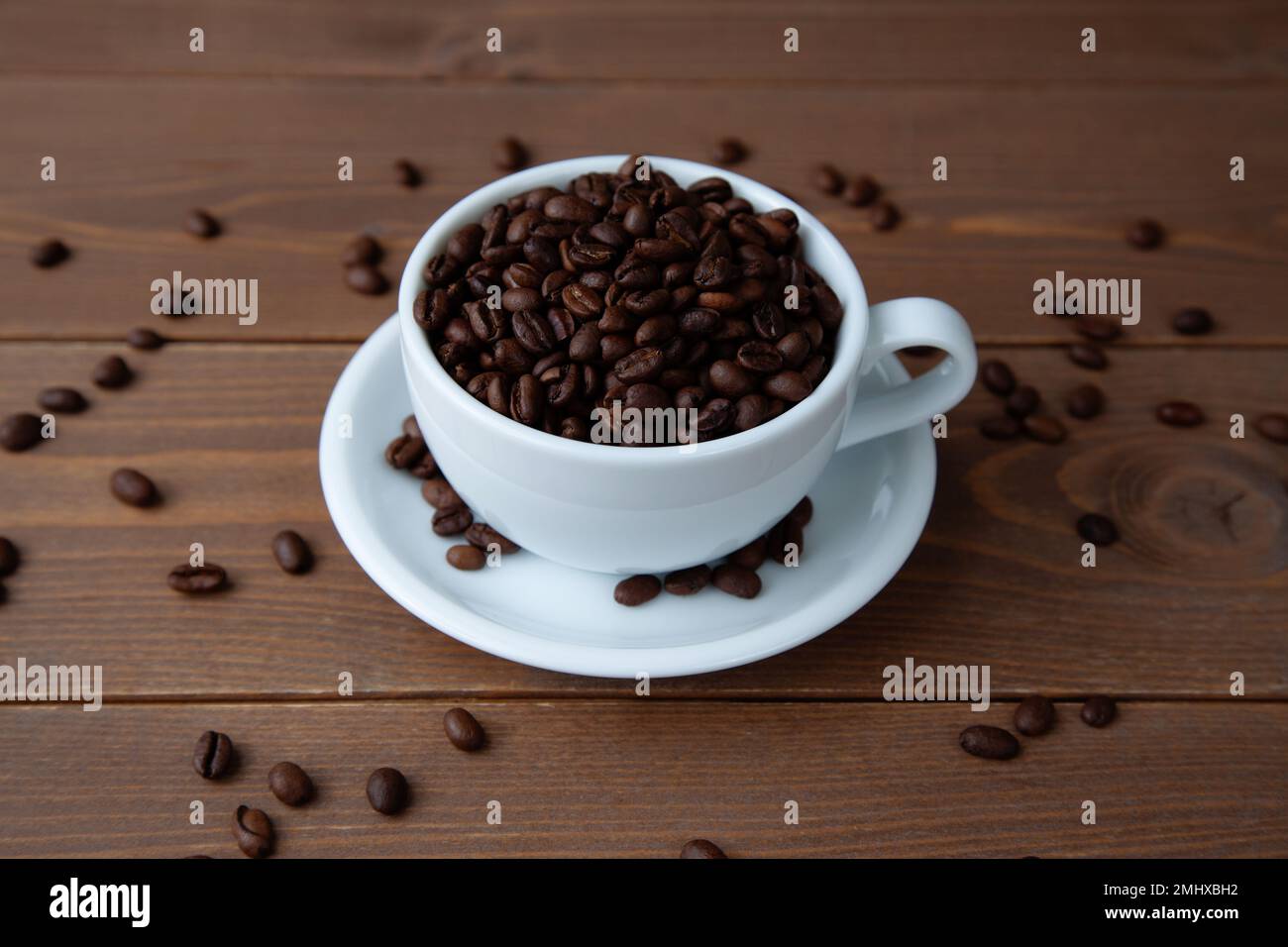 roasted coffee beans in coffee cup on table Stock Photo