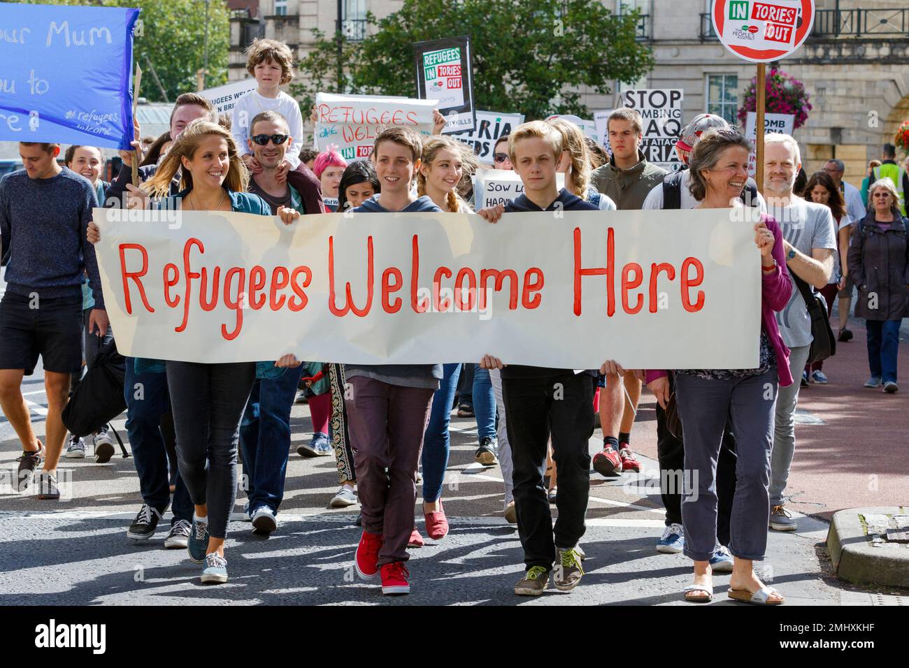 Bristol, UK, 12-09-2015. Protesters carrying placards and banners are pictured marching through Bristol during a demonstration in support of refugees Stock Photo