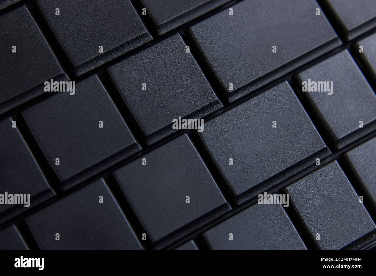 Black computer keyboard, macro photo, selective focus. Place for text on keyboard button. Stock Photo