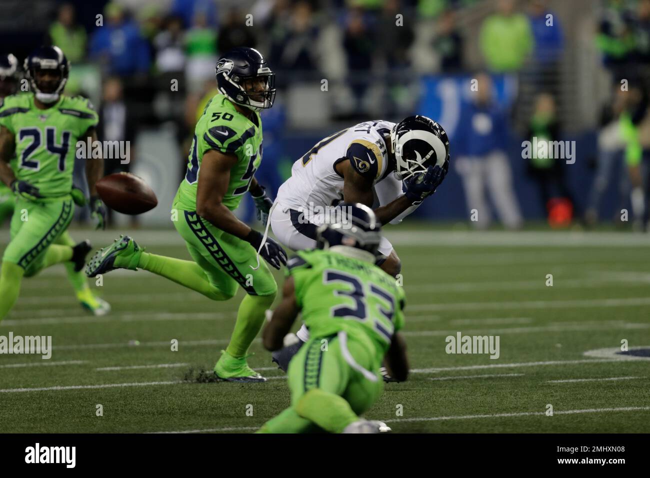 Seattle Seahawks free safety Tedric Thompson (33) reaches out to intercept  a pass intended for Los Angeles Rams tight end Gerald Everett, center,  during the second half of an NFL football game,