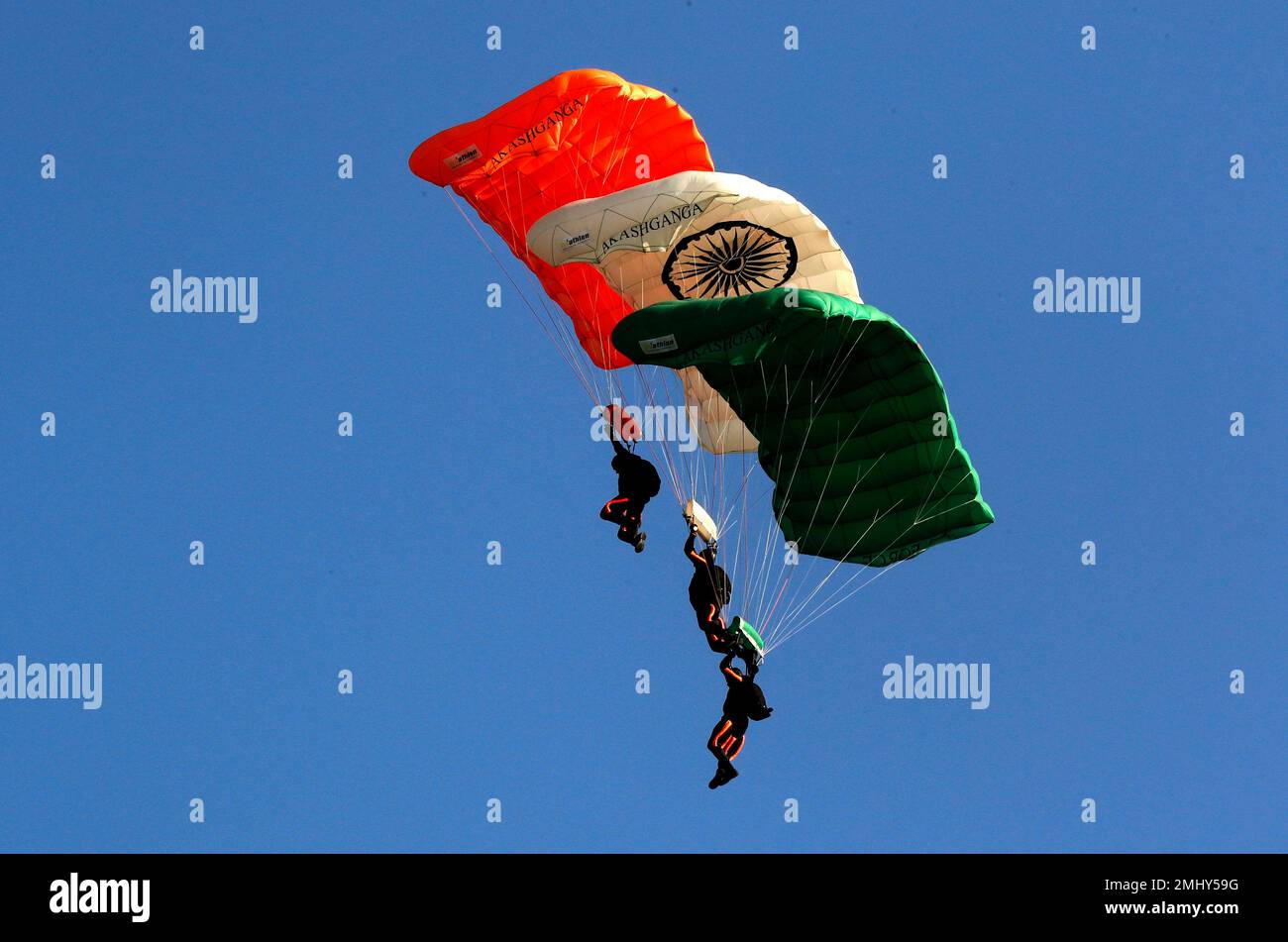 Members of Akash Ganga sky diving team of the Indian Air Force display  their skill during Air Force Day parade at the Hindon air base on the  outskirts of New Delhi, India