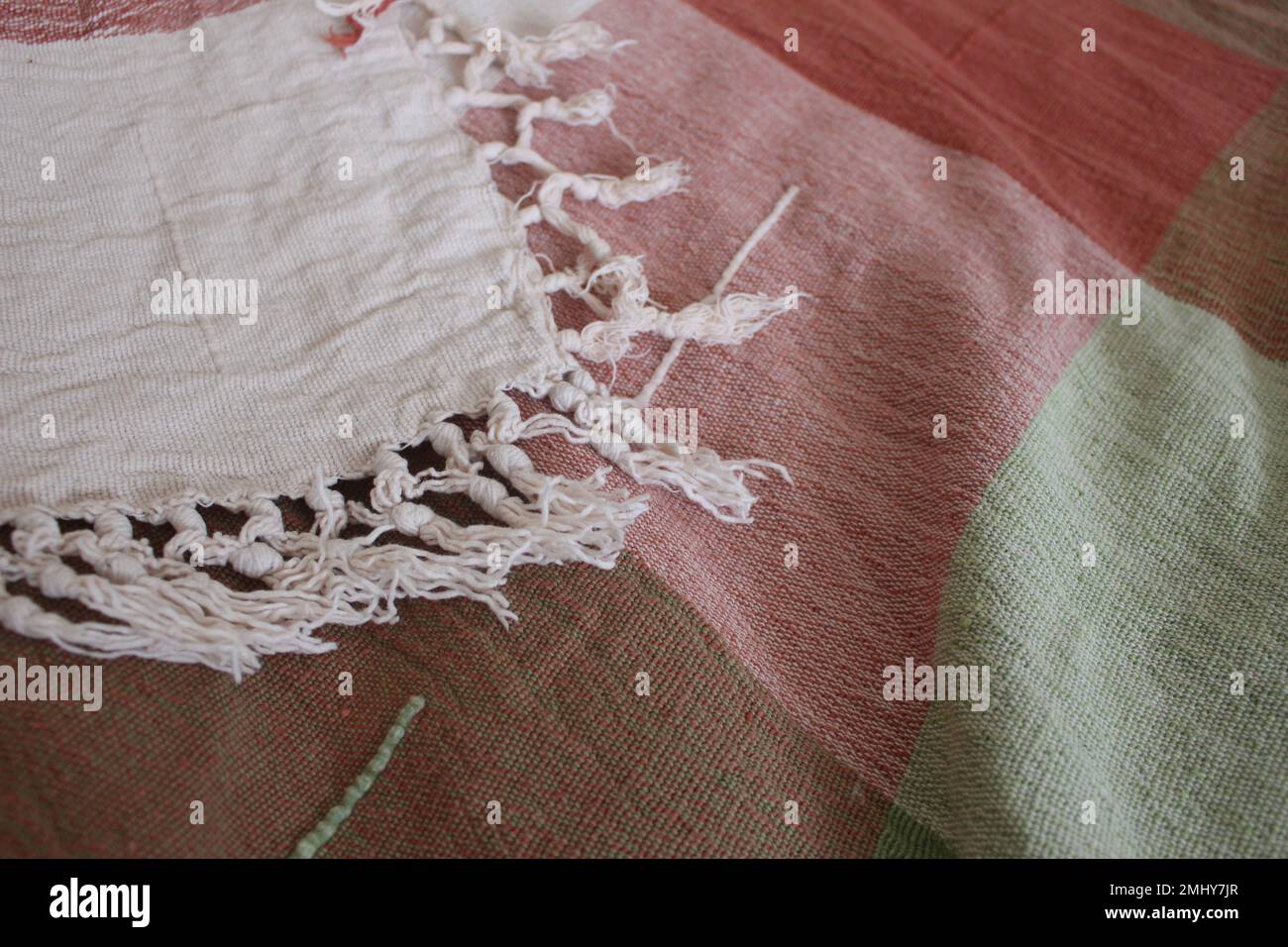 Comfortable warm cozy blanket with white tassels Stock Photo