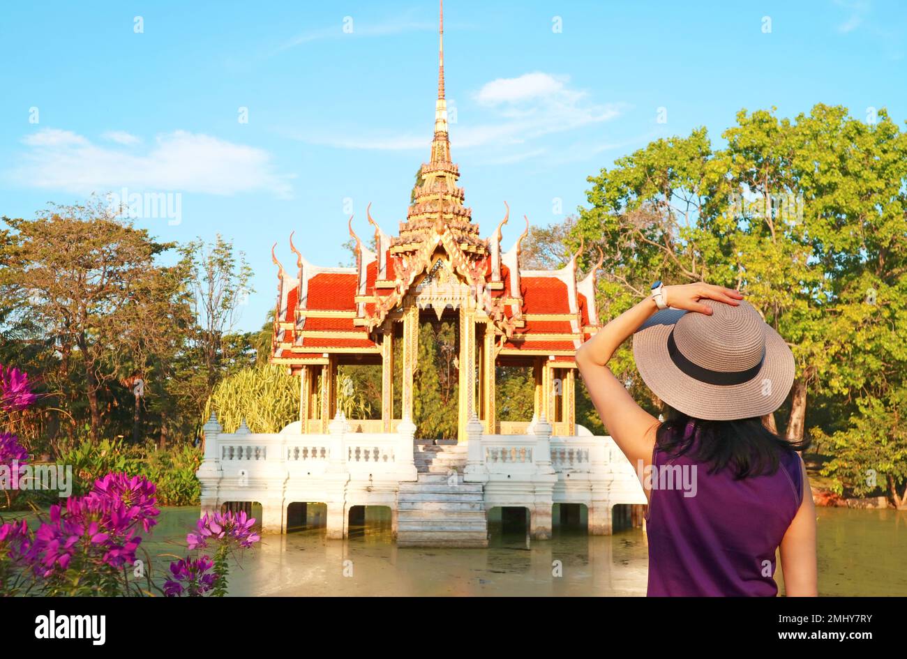 Female Visitor Impressed by a Gorgeous Thai Ancient Style Pavilion on the Lotus Pond of Suanluang King Rama IX Park, Bangkok, Thailand Stock Photo