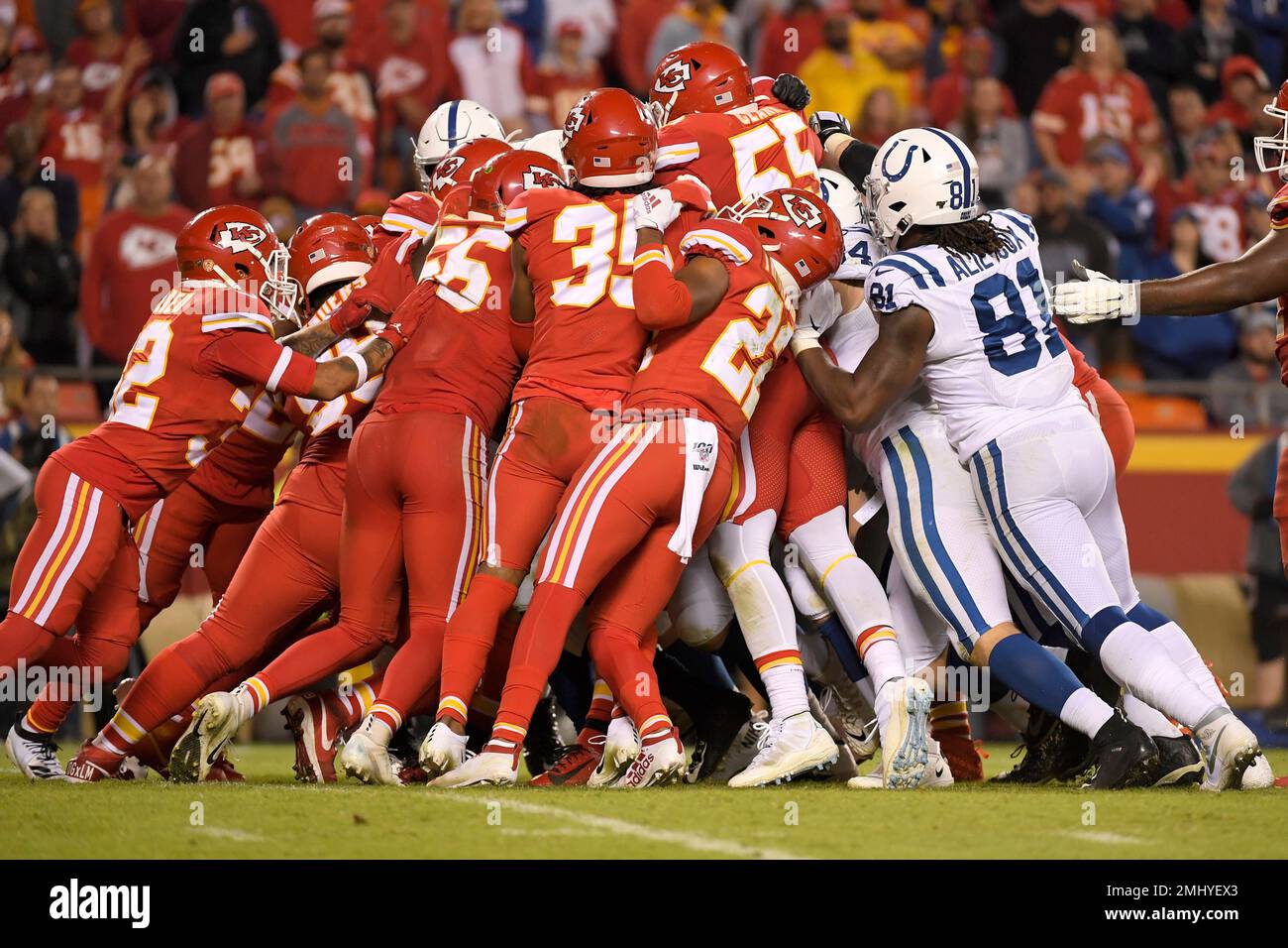 A scrum of Kansas City Chiefs players, left, struggles to stop an