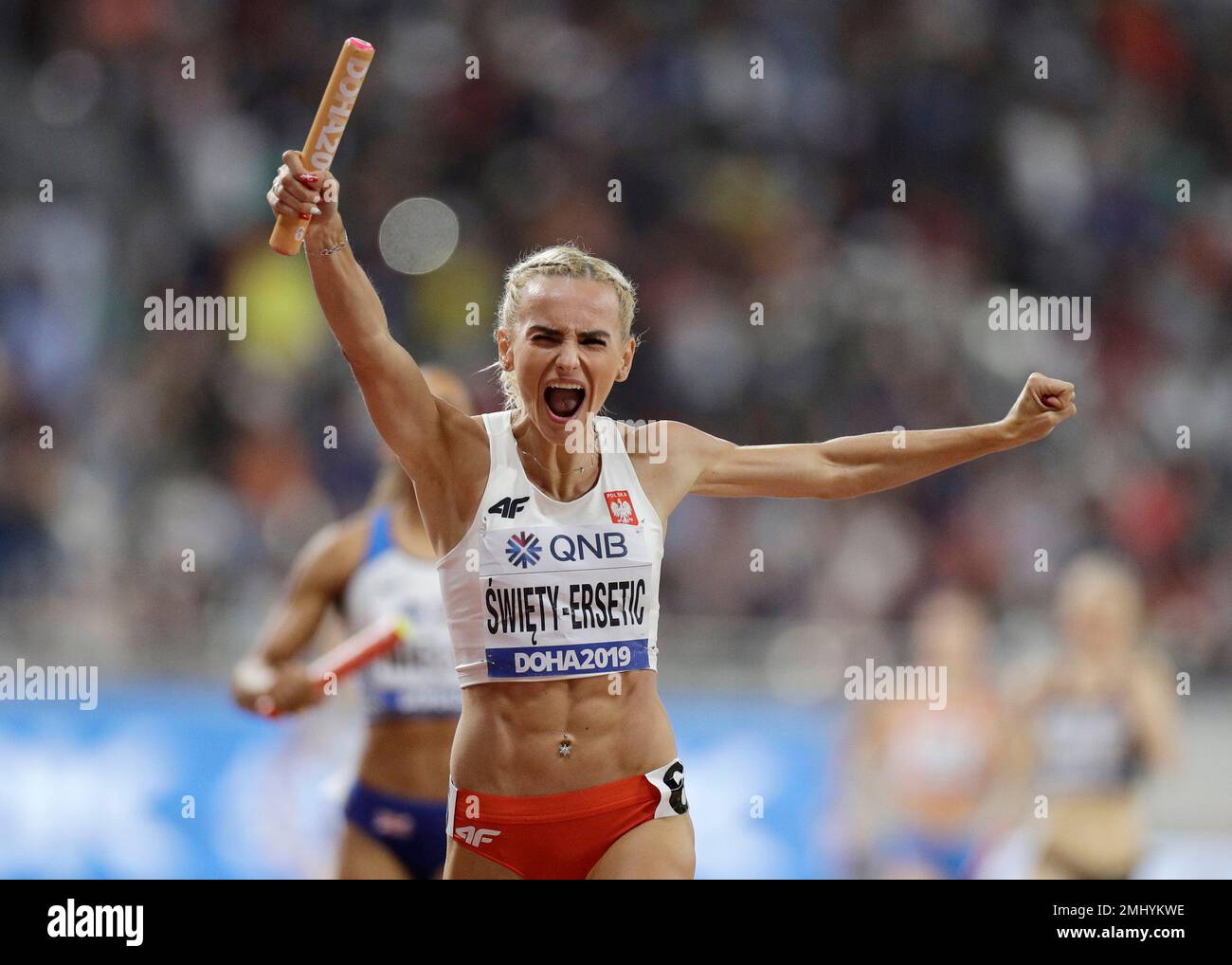 Poland's Justyna SwietyErsetic celebrates as she crosses the finish