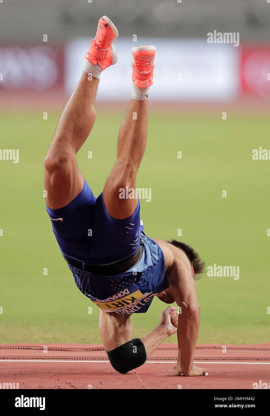 Magnus Kirt, of Estonia falls on his elbow after throwing in the men's