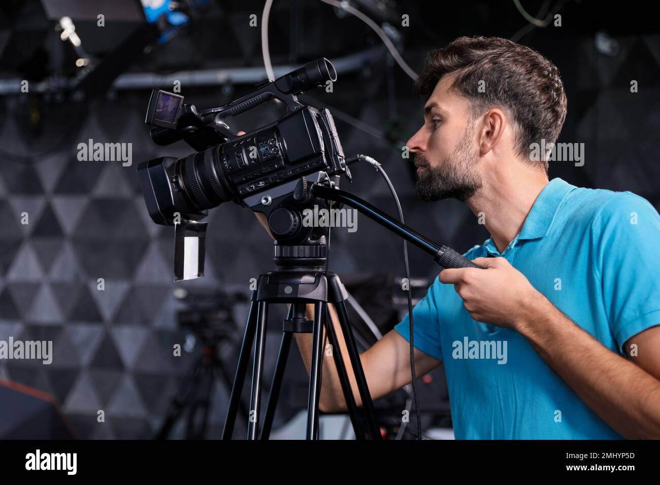 Professional video camera operator working in studio Stock Photo Alamy