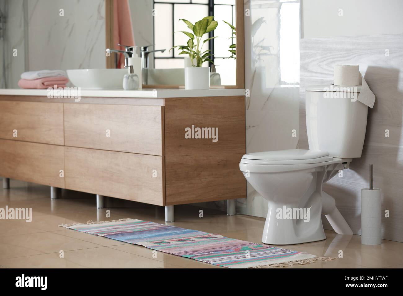 Interior of modern bathroom with toilet bowl Stock Photo - Alamy