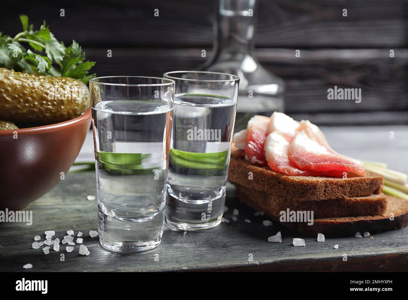 Cold Russian vodka with snacks on wooden table Stock Photo