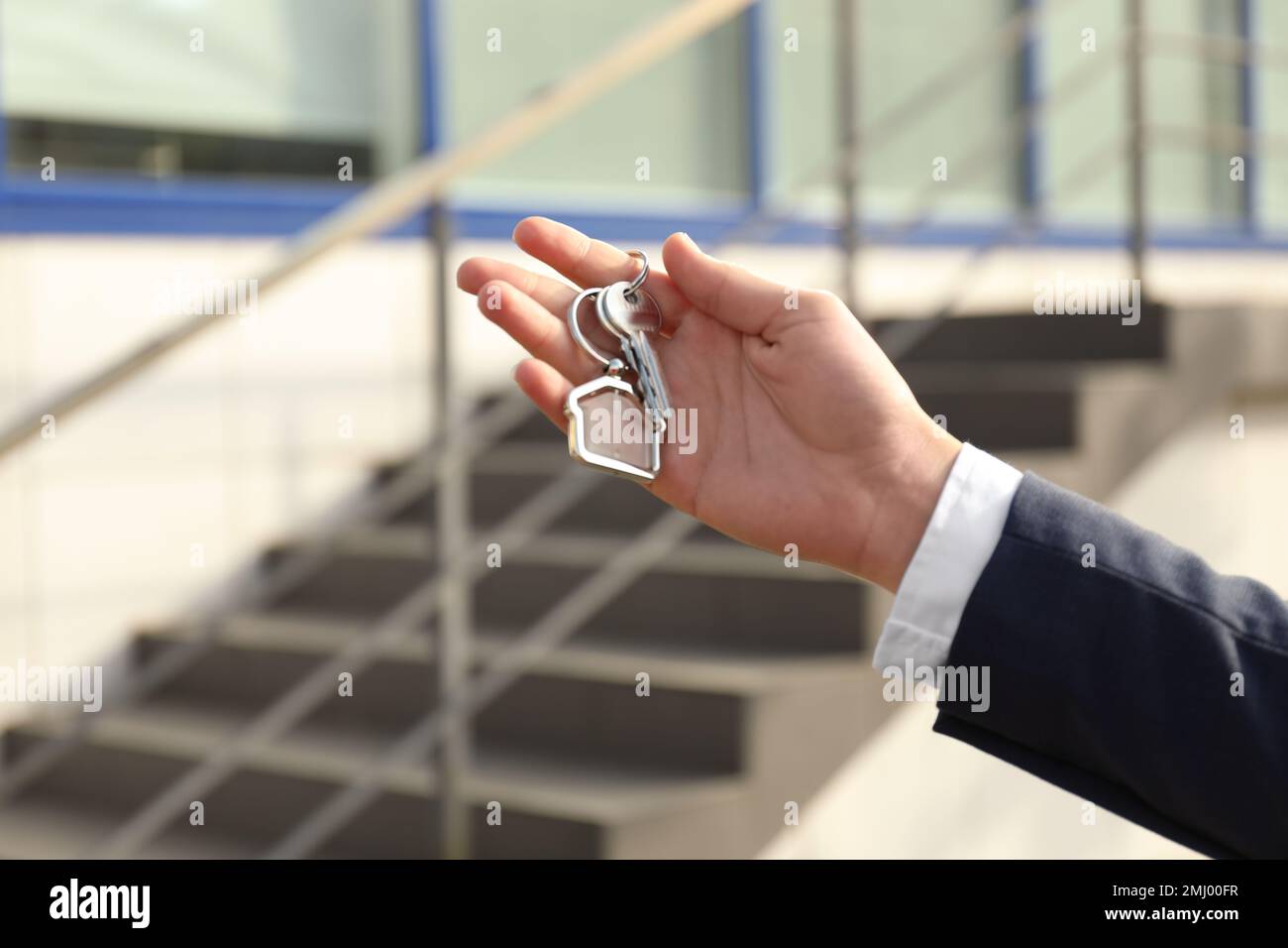 Real estate agent holding keys outdoors, closeup Stock Photo - Alamy