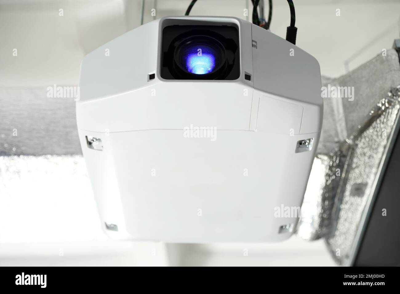 Modern video projector hanging on ceiling, closeup Stock Photo Alamy