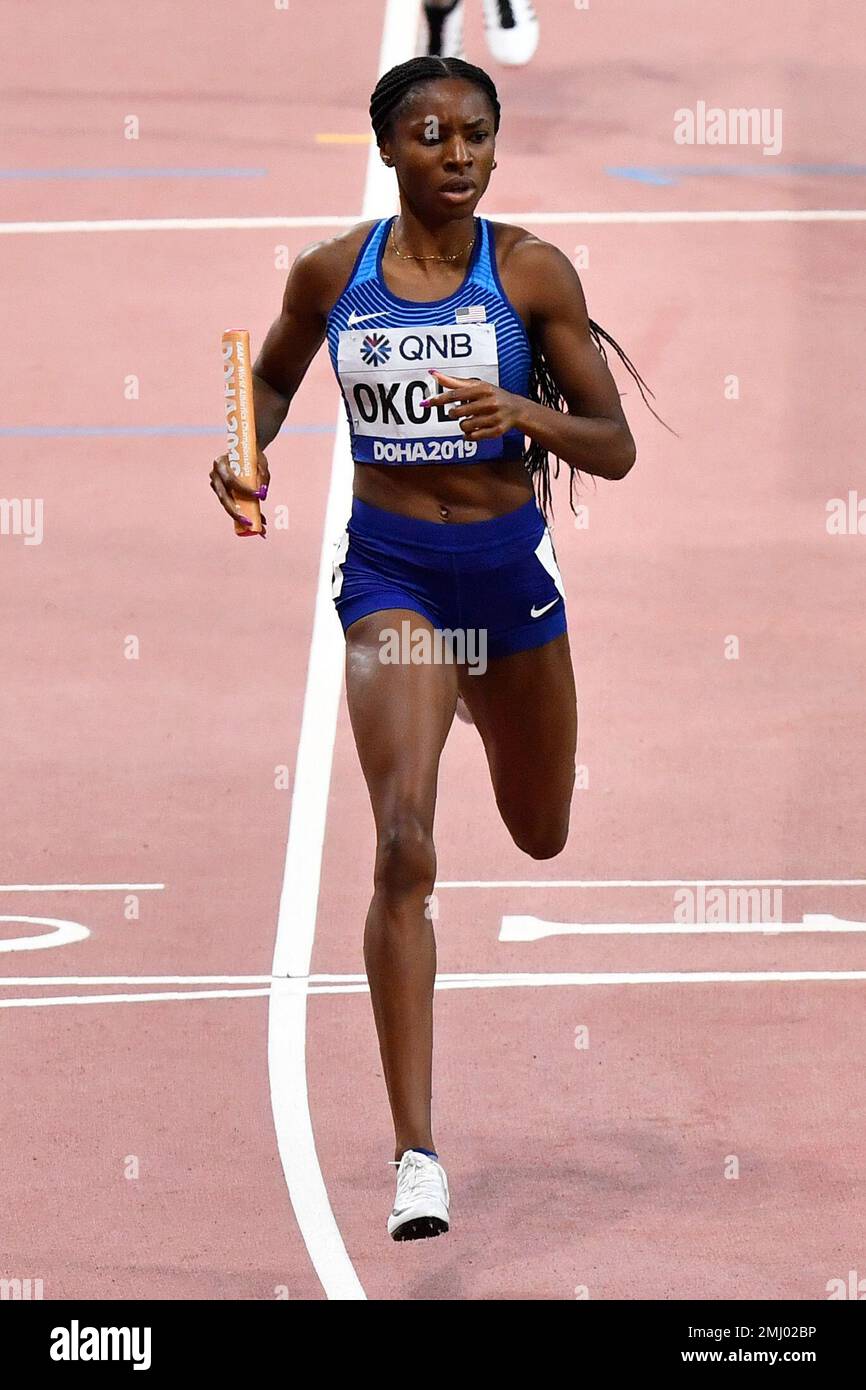 Courtney Okolo of the United States crosses the finish line to win her