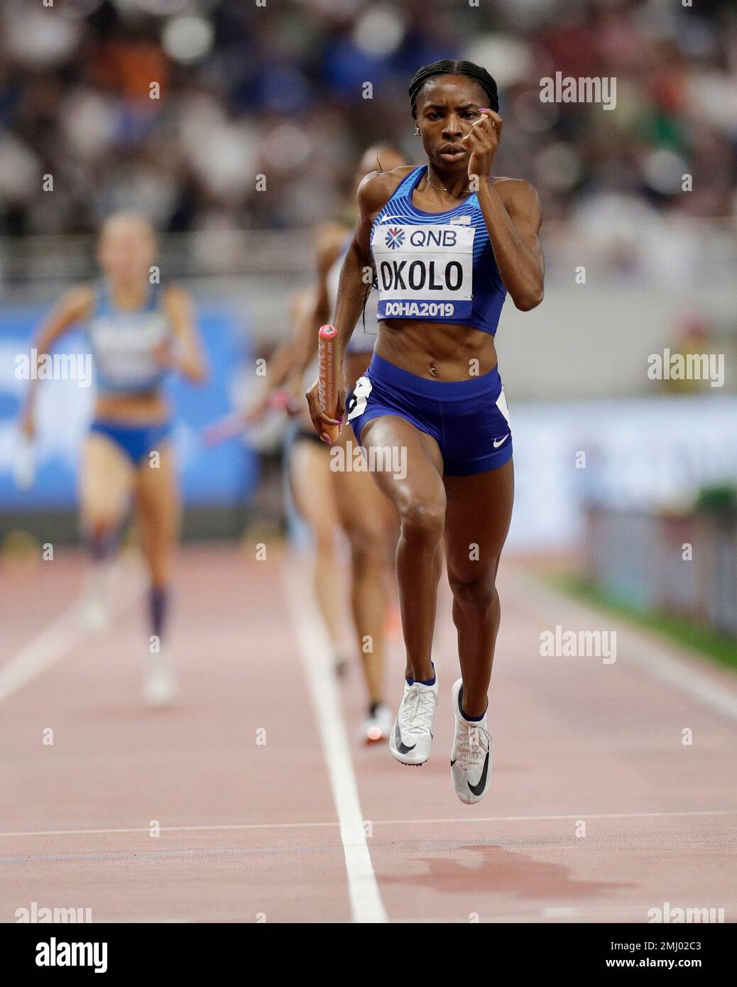 Courtney Okolo of the United States leads her team to win a women's