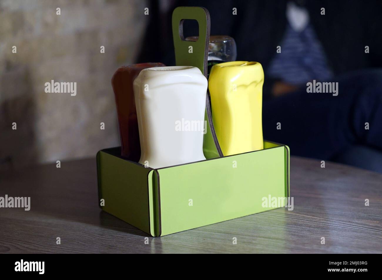 sauce dispenser, wooden saucer, ketchup mayonnaise mustard Stock Photo