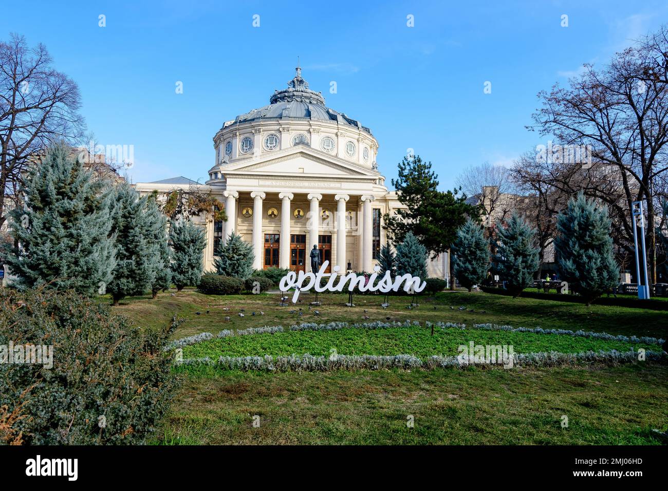 Bucharest, Romania, 2 January 2022: Optimism word displayed in front of