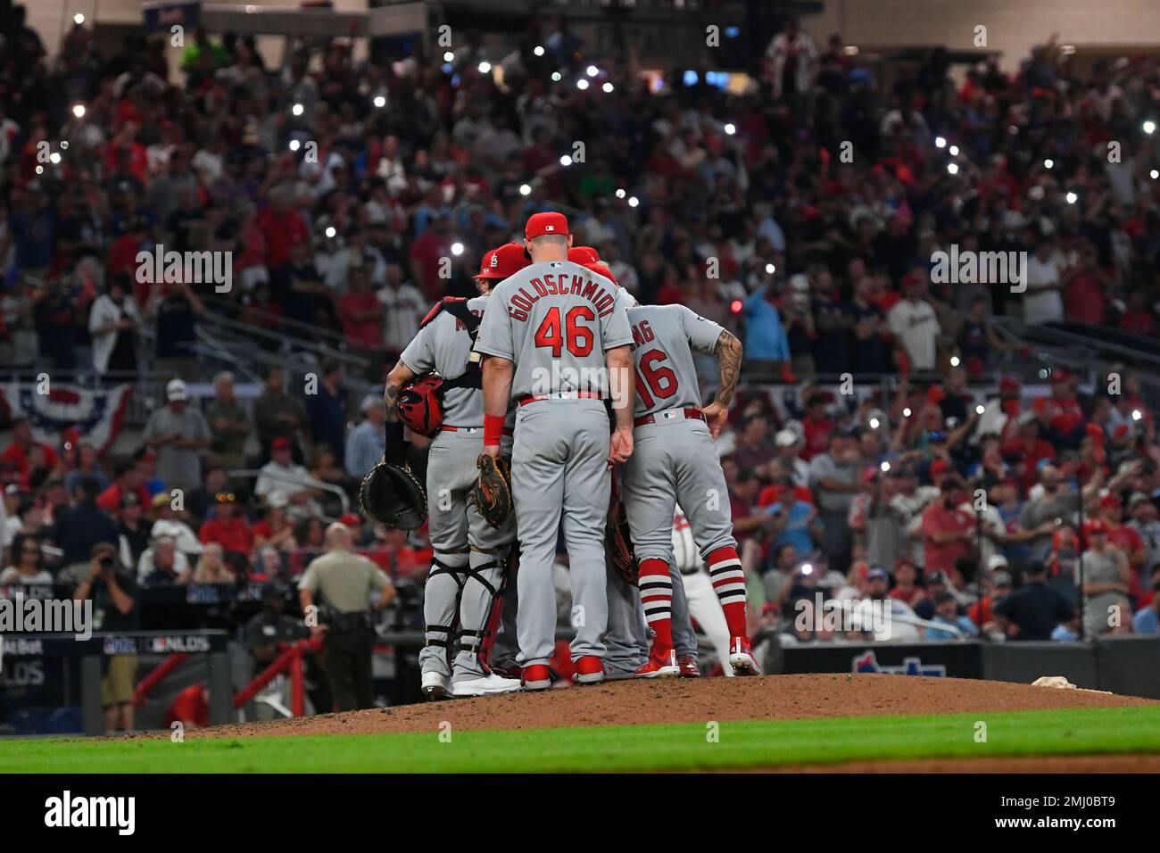 St. Louis Cardinals players converse on the mound in the eighth inning  during Game 1 of a best-of-five National League Division Series against the  Atlanta Braves, Thursday, Oct. 3, 2019, in Atlanta. (