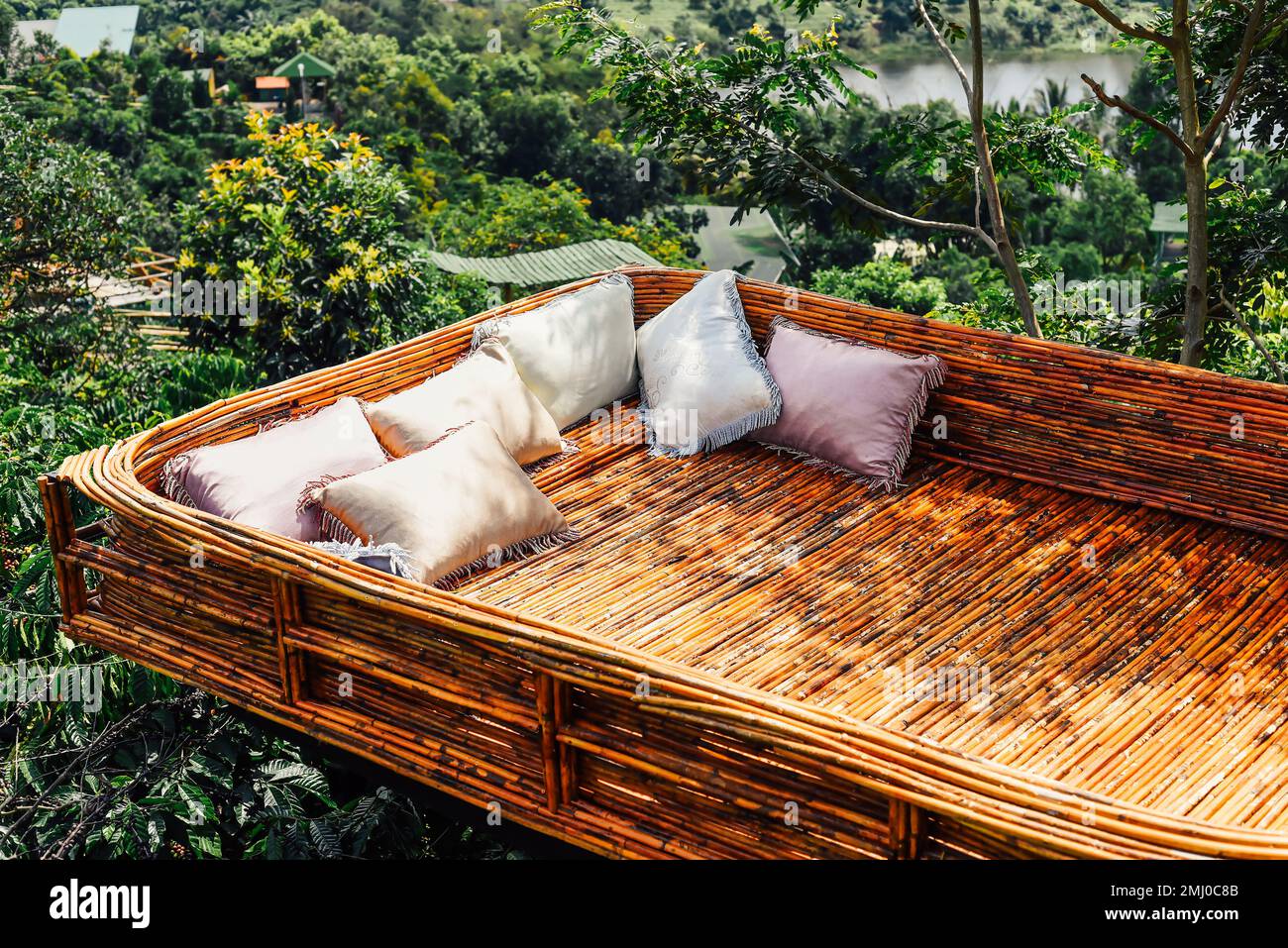 Creative objects in Vietnam wooden bed with cozy pillows against