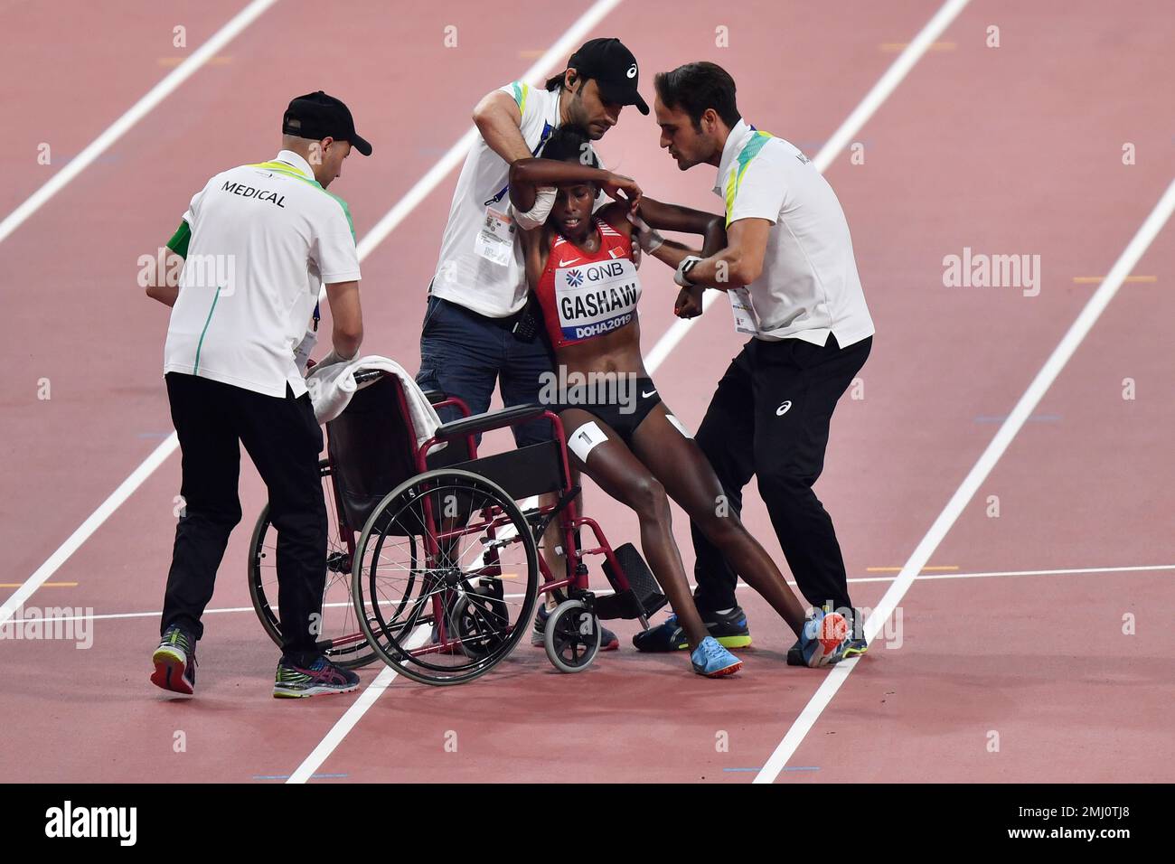 Tigist Gashaw, of Bahrain, is carried into a wheelchair after