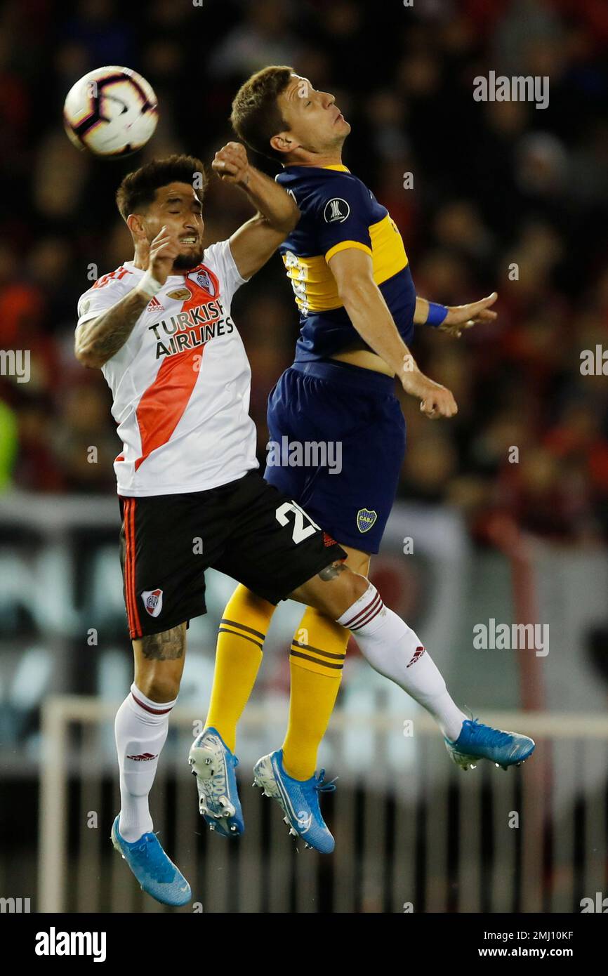 Rafinha of Brazil's Flamengo heads the ball challenged by Milton Casco of  Argentina's River Plate during the Copa Libertadores final soccer match at  the Monumental stadium in Lima, Peru, Saturday, Nov. 23