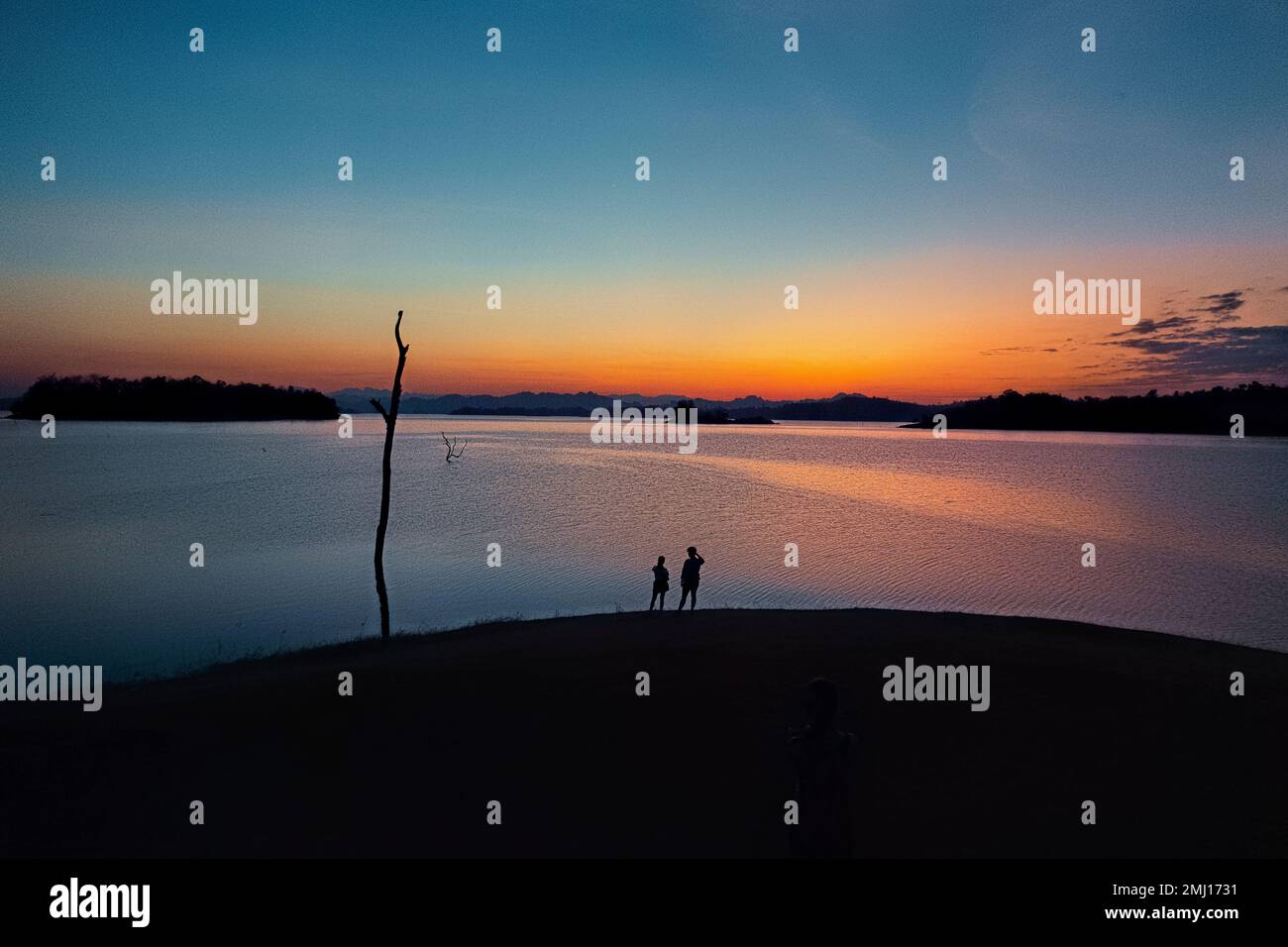 Enjoying sunset along the Vajiralongkorn Reservoir, Khao Laem National Park, Kanchanaburi, Thailand Stock Photo
