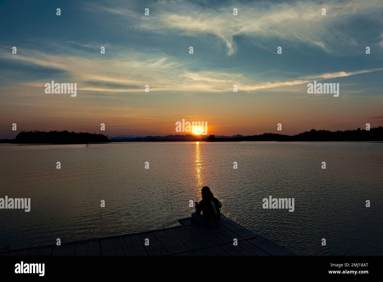 Enjoying sunset along the Vajiralongkorn Reservoir, Khao Laem National Park, Kanchanaburi, Thailand Stock Photo