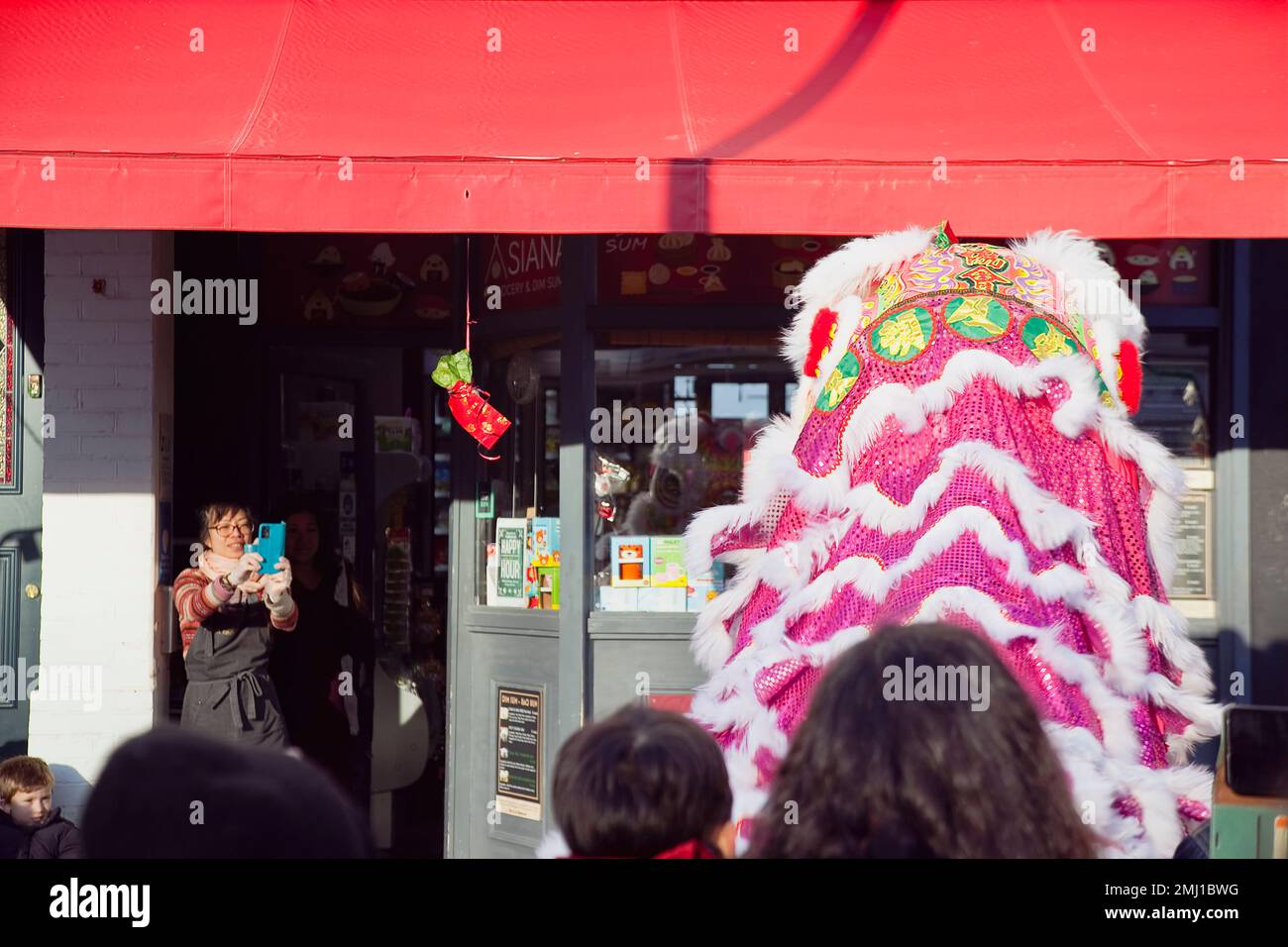 England, East Sussex, Hove, Portland Road, Dragon dance outside Asiana shop for Chinese New Year 2023, the year of the Rabbit. Stock Photo