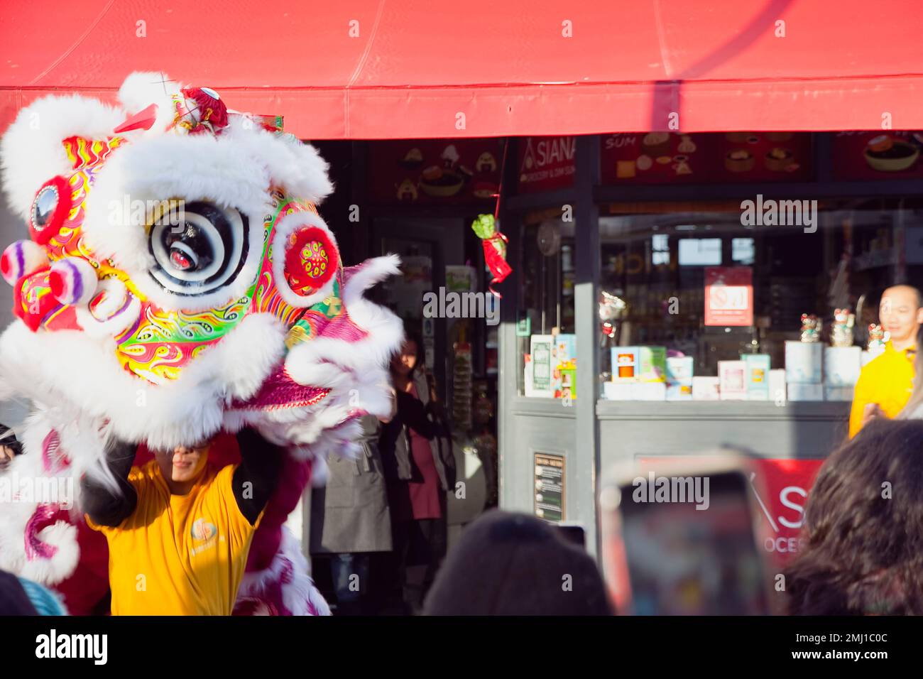 England, East Sussex, Hove, Portland Road, Dragon dance outside Asiana shop for Chinese New Year 2023, the year of the Rabbit. Stock Photo