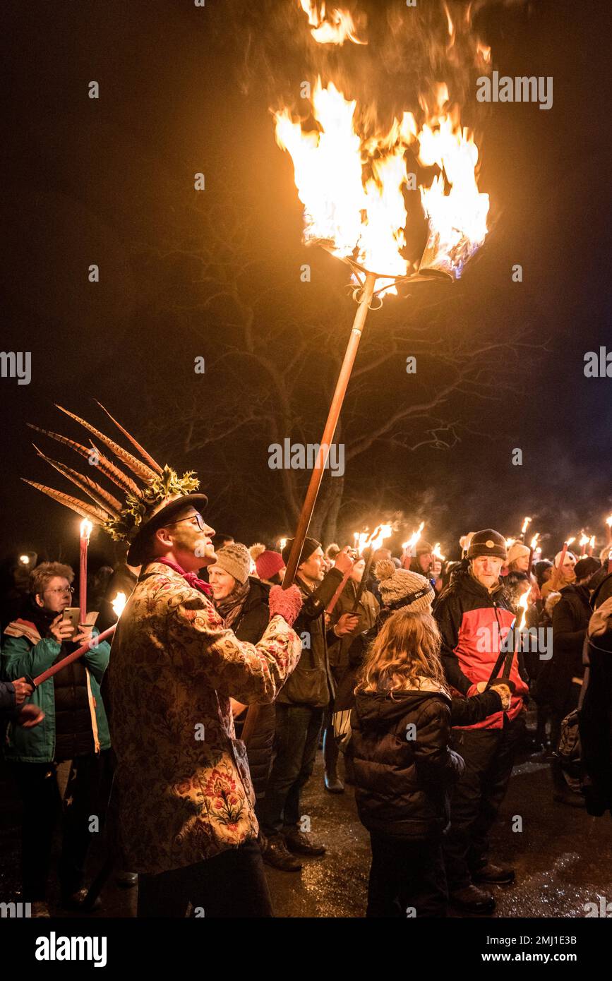 One of the Leominster Morris carries a flaming torch at the annual Twelfth Night torchlight procession and wassail at Burton Court, Herefordshire, UK Stock Photo