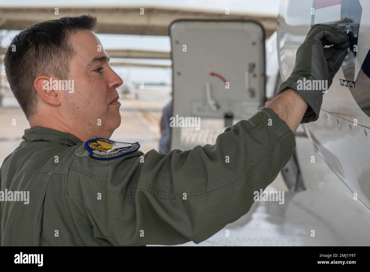 U.S. Air Force Maj. Ryan Wasson, 39th Flying Training Squadron instructor pilot, checks the fuel level gauge on a Raytheon T-1 Jayhawk, assigned to the 99th Flying Training Squadron before flight at Joint Base San Antonio-Randolph, Texas, August 15, 2022. A part of the 99th FTS’s pre-flight checklist includes examining multiple parts of the aircraft before take off to ensure the plane is suitable for flight. Stock Photo