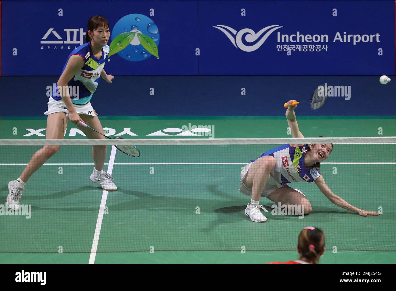 Japans Chiharu Shida, right, returns a shot as her teammate Nami Matsuyama watches during the womens doubles semi-final match against South Koreas Lee So-hee and Shin Seun-chan at the Korea Open Badminton