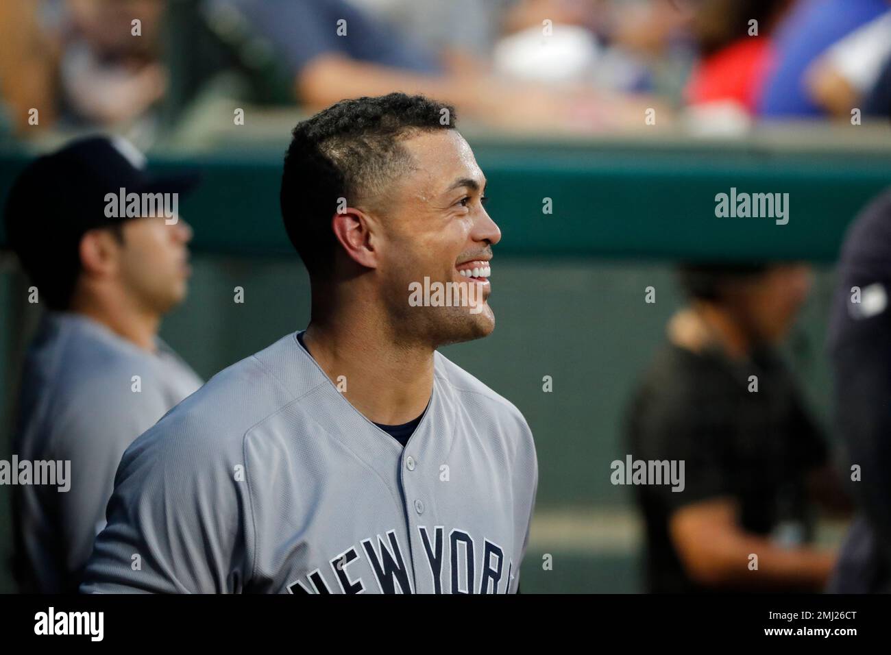 Giancarlo Stanton holds up his new No. 27 Yankees jersey.