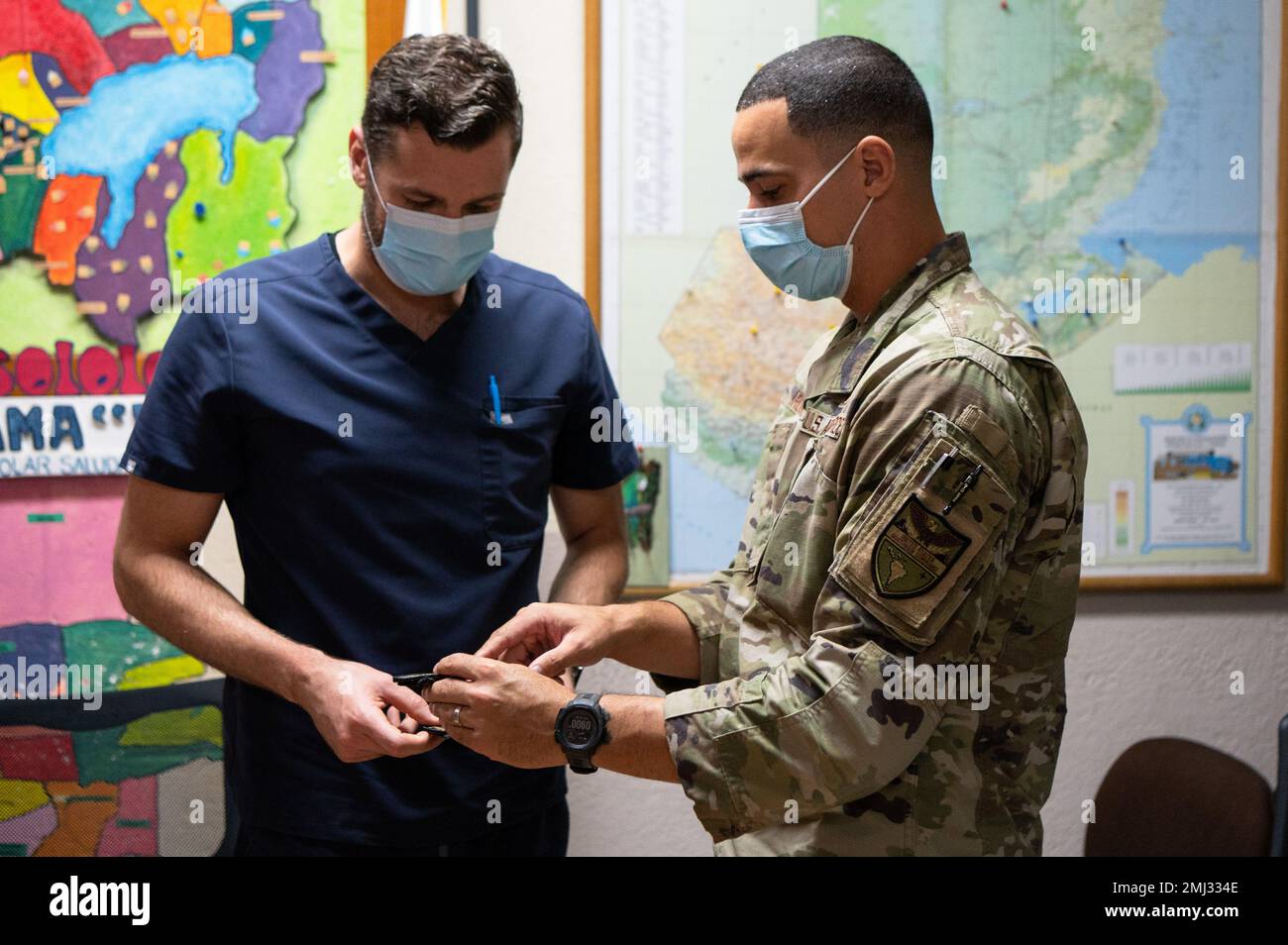 U.S. Air Force Capt. Alexandre Rogan, right, the Health Engagements Assistance Response Team (HEART) 2022 officer in charge, gives unit patches to Dr. Alfonso Wer Rodríguez, the administrative council president at Unidad Nacional de Oftalmología, in Guatemala City, Aug. 25, 2022. Leadership from UNO were gifted unit patches from HEART 22 to thank them for their support and partnership throughout the operation. Stock Photo