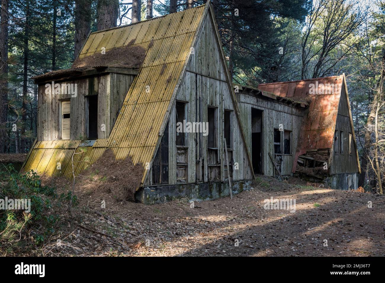 An empty and derelict hut in an old abandoned ski resort in the woods on Mount Etna, Sicily, Italy Stock Photo