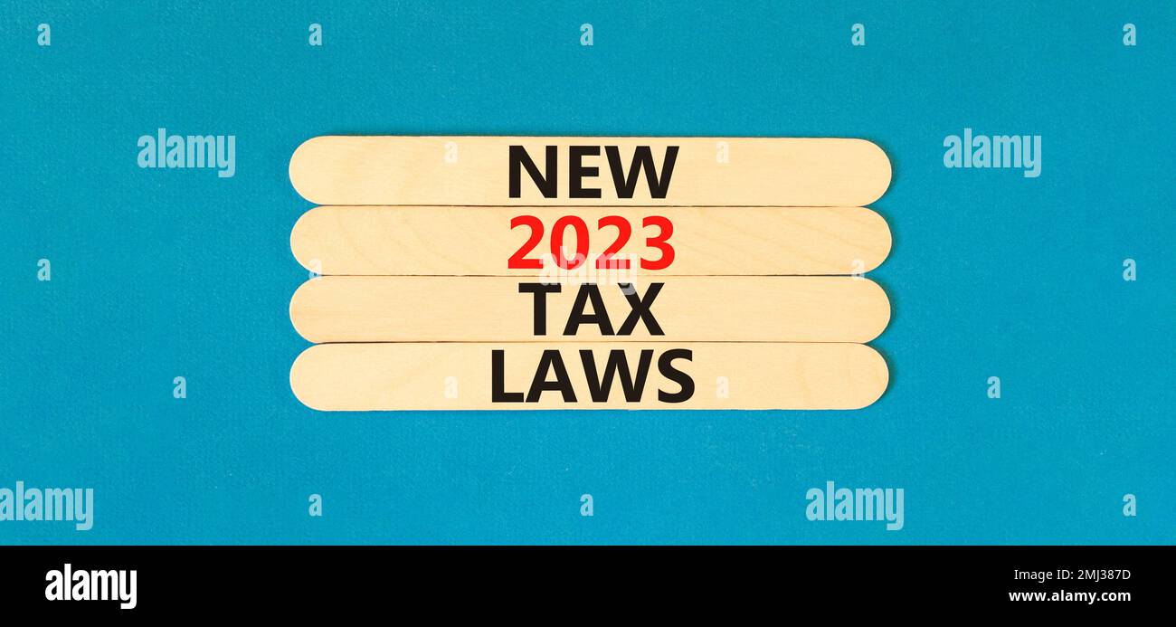 New 2023 tax laws symbol. Concept words New 2023 tax laws on wooden stick. Beautiful blue table blue background. Business new 2023 tax laws concept. C Stock Photo