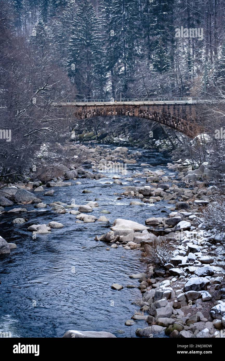 Bridge over stony river in winter with snow, Black Forest, Germany Stock Photo