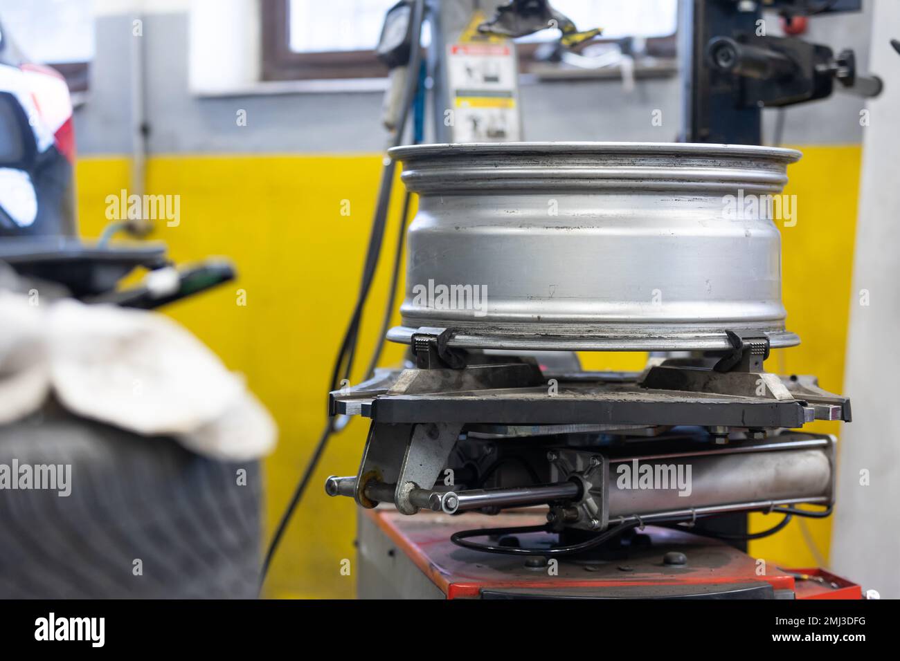 Car, auto mechanic changing tires, wheels on the car by pneumatic wrench, service center Stock Photo