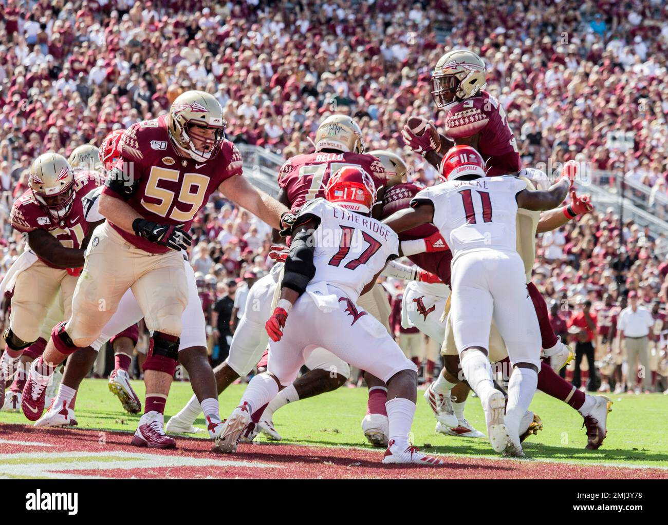 Florida State Seminoles running back Cam Akers (3) attempts to go over