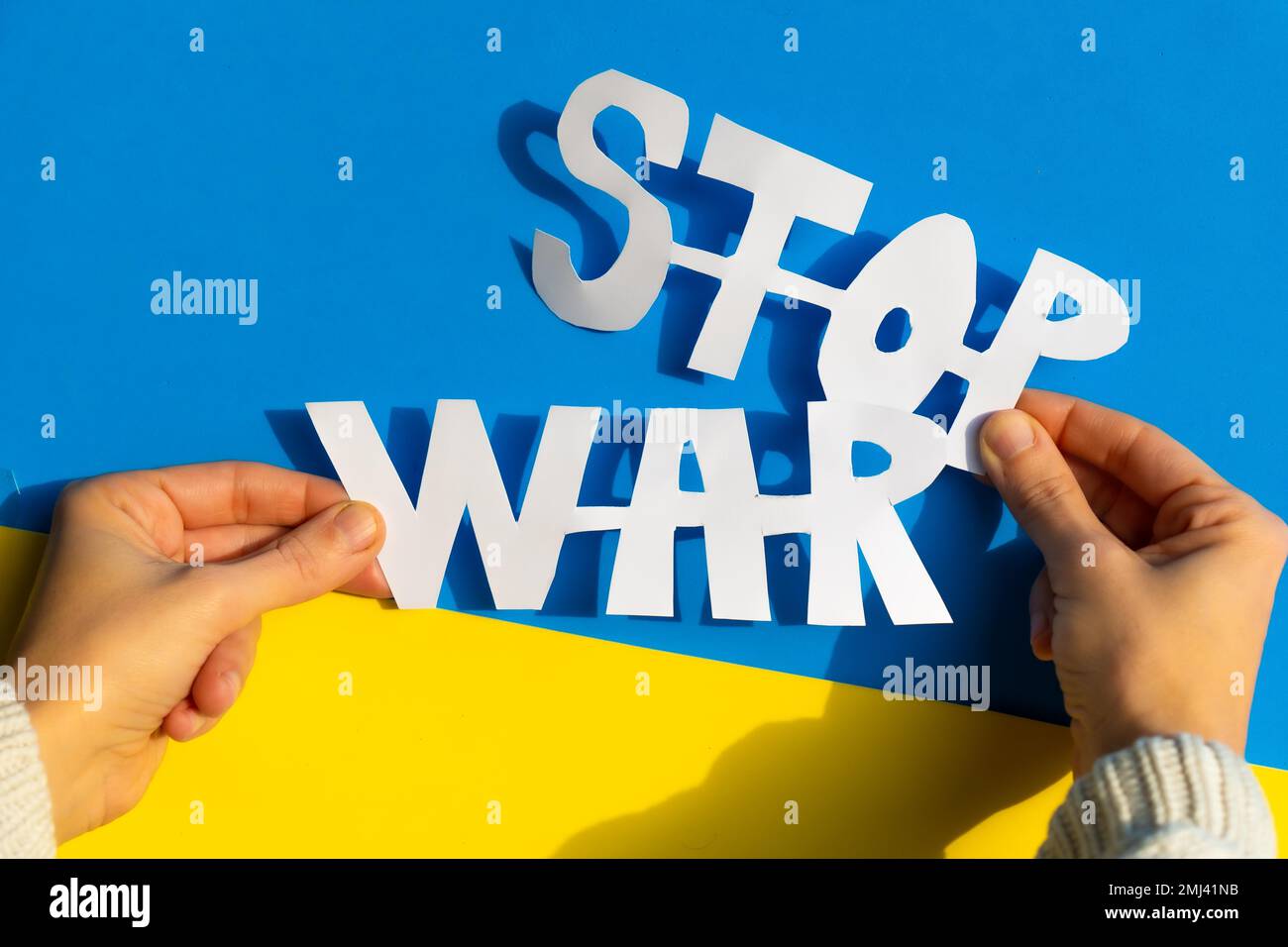 Stop war, conflict between Ukraine and Russia. Hands of a woman holding an anti war symbol Stock Photo