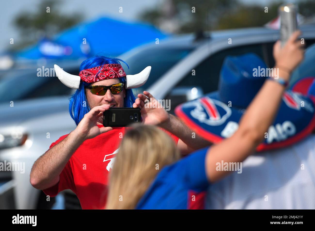 Buffalo Bills fans pose for photographs in the parking lot of New Era  Stadium before a NFL football game against the Cincinnati Bengals Sunday,  Sept. 22, 2019., in Orchard Park, N.Y. (AP