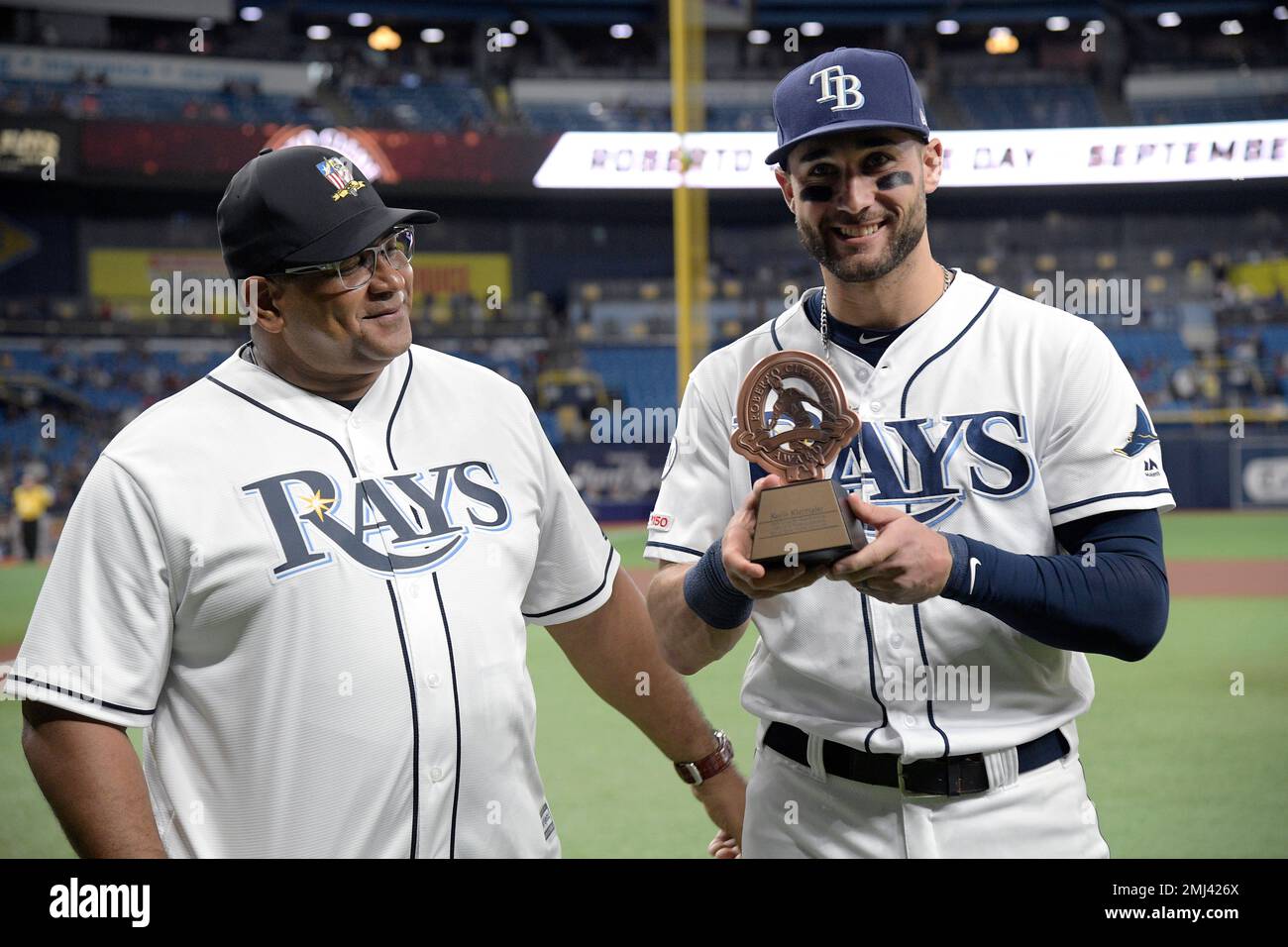 Tampa Bay Rays center fielder Kevin Kiermaier, right, shakes hands with  Luis Clemente, son of Roberto Clemente, after receiving a trophy for being  the Rays' nominee for the Roberto Clemente Award, given