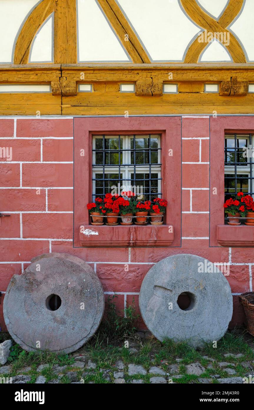 Two millstones in front of the mill, 1575, Franconian Open Air Museum, Bad Windsheim, Middle Franconia, Bavaria, Germany Stock Photo