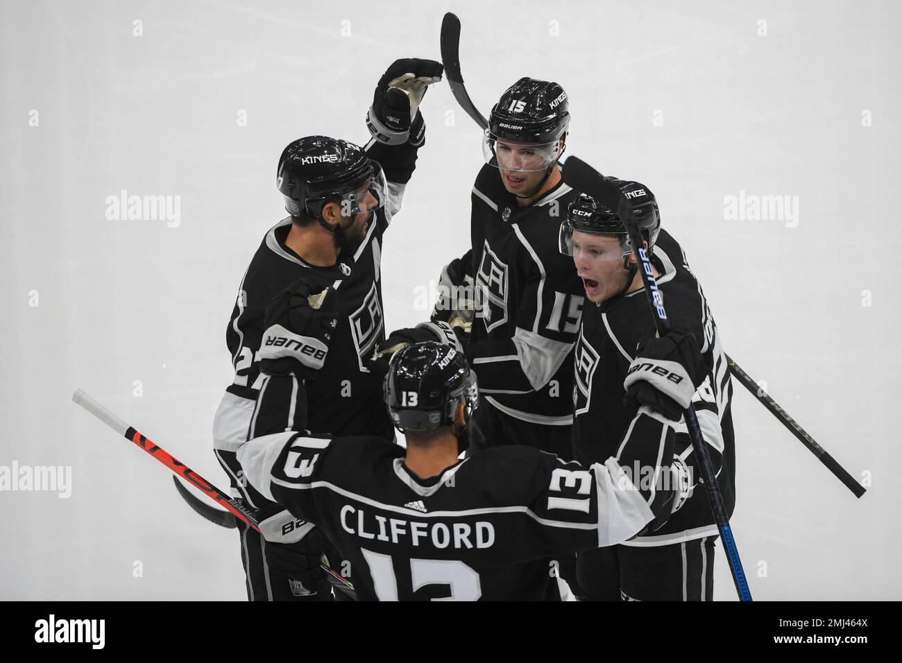 Los Angeles Kings defenseman Alec Martinez, left, defenseman Ben Hutton,  center and center Jaret Anderson-Dolan, right, celebrate a goal during the  first period of a preseason NHL hockey game against the Vancouver